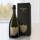 Dom Perignon Gift Boxed Vintage Champagne: A bottle of Dom Pérignon Vintage 2006 champagne stands next to its black gift box, placed on a white surface with soft natural light in the background. Dom Perignon Gift Boxed Vintage Champagne: A bottle of Dom Pérignon Vintage 2006 champagne stands next to its black gift box, placed on a white surface with soft natural light in the background.